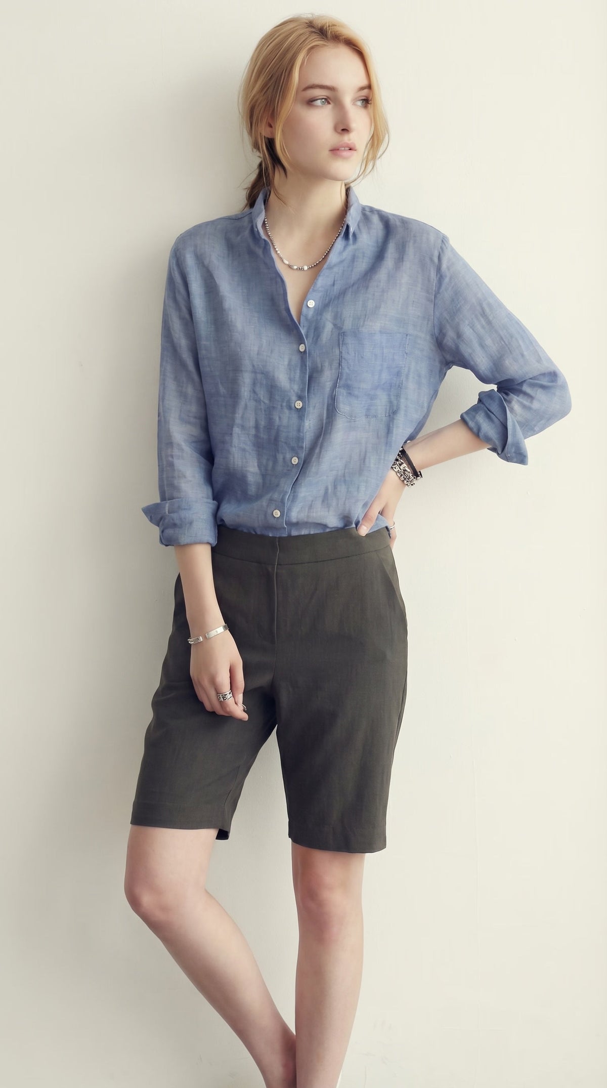LORVENE classic button-up shirt in light blue with a collar and long sleeves, displayed on a hanger.