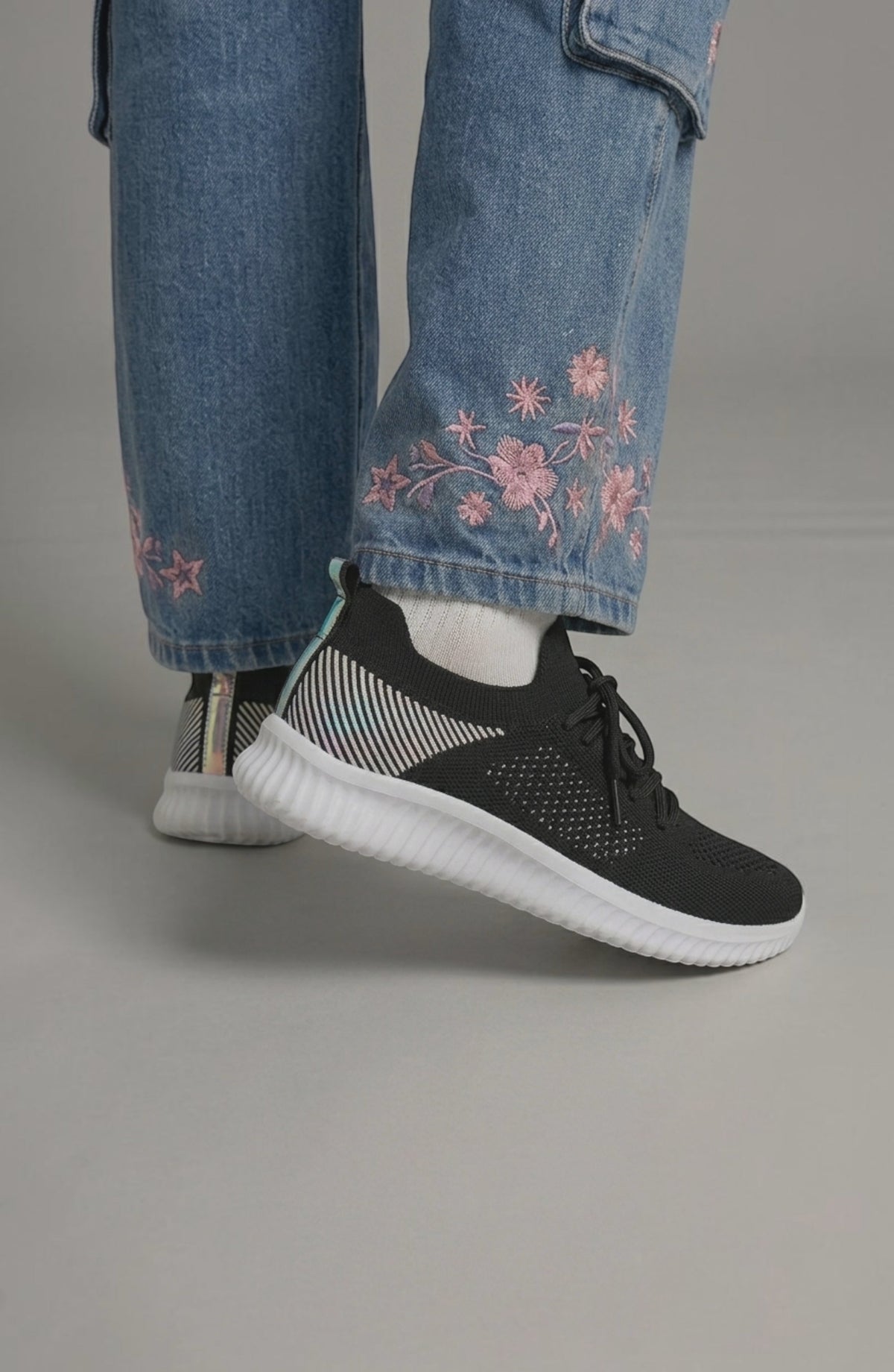 LORVENE Polar Crest sneakers in white with gray accents, showing the side view of sporty athletic shoes with laces and textured soles.