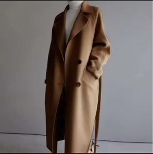 Brown coat on a mannequin against a plain background
