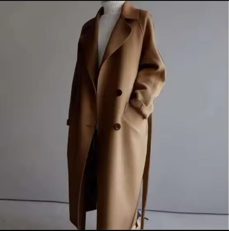 Brown coat on a mannequin against a plain background