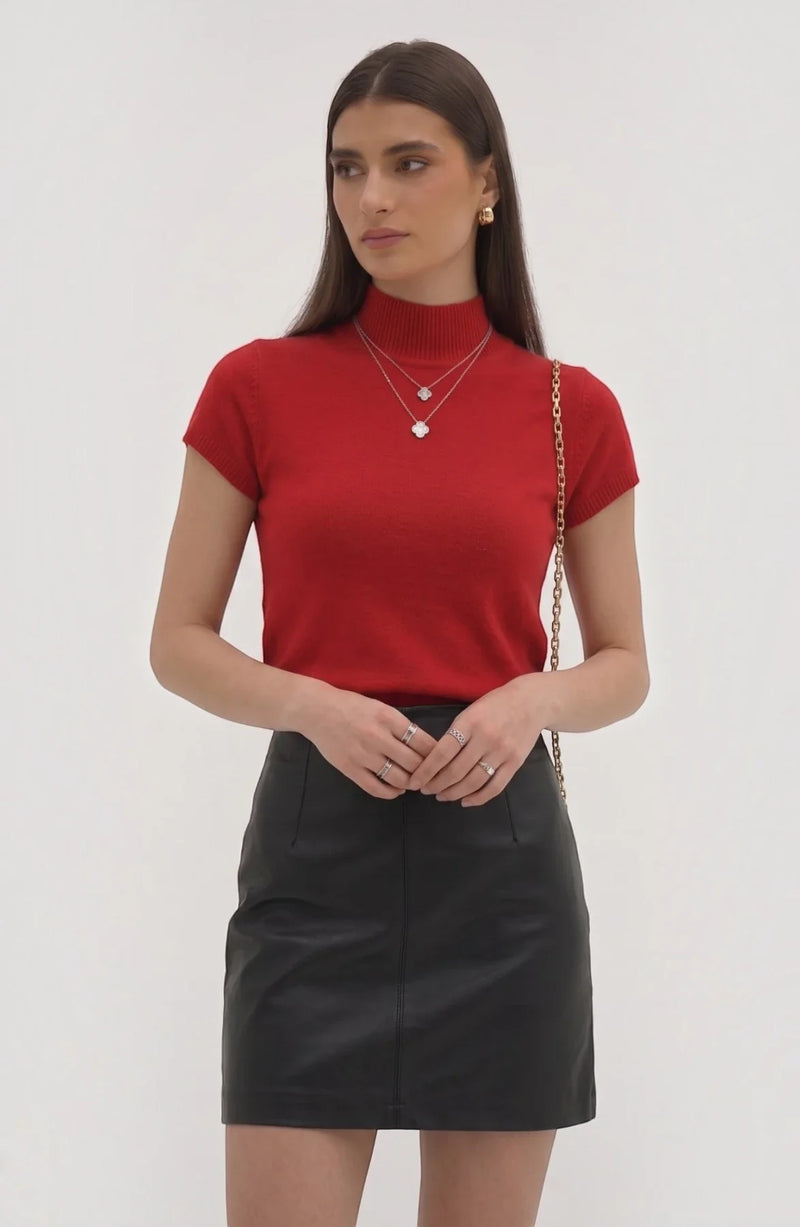 LORVENE Pure Poly Blend High Neck sweater displayed on a hanger, showcasing its soft fabric and high neckline design.