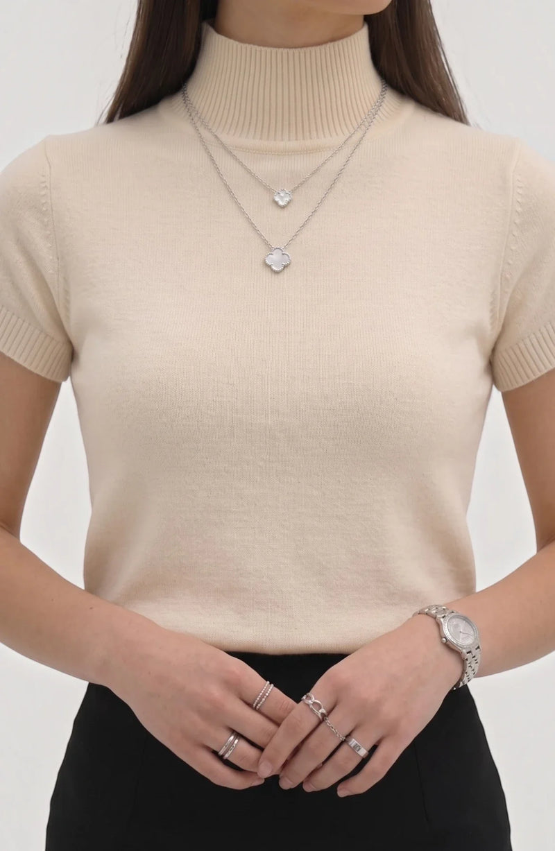 LORVENE Pure Poly Blend High Neck top in neutral color, featuring a close-up of the high neckline and smooth fabric texture.