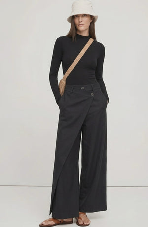 LORVENE Curve Form Pants shown from top left pose, highlighting the fitted waist and sleek design in a neutral fabric.