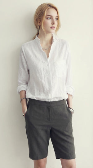 LORVENE classic button-up shirt in crisp white fabric, featuring a collar and long sleeves, displayed on a hanger.