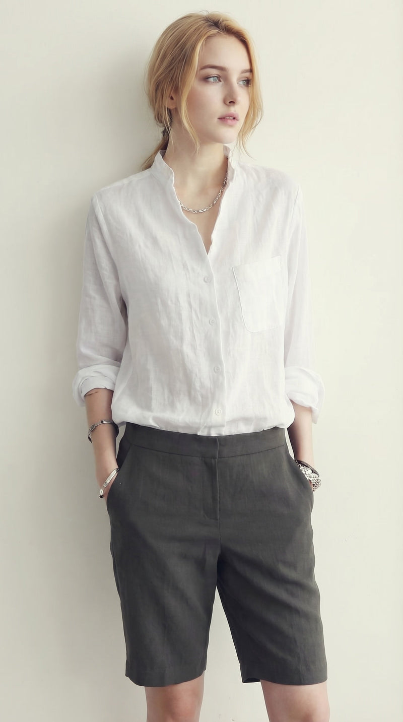 LORVENE classic button-up shirt in crisp white fabric, featuring a collar and long sleeves, displayed on a hanger.