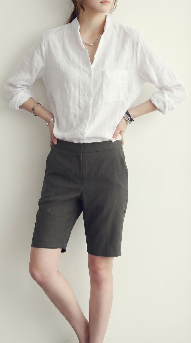 LORVENE classic button-up shirt in crisp white fabric, featuring a collar and long sleeves, perfect for casual or formal wear.