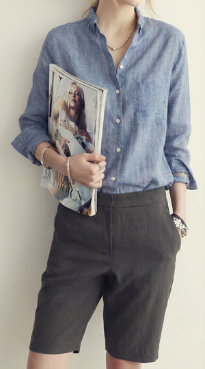 LORVENE classic button-up shirt in light blue fabric, featuring a collar and long sleeves, displayed on a hanger.