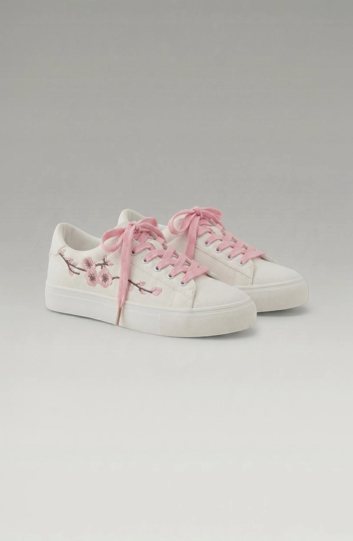 LORVENE Crystal Tone Sneakers featuring clear and sparkling design with white soles and stylish accents.