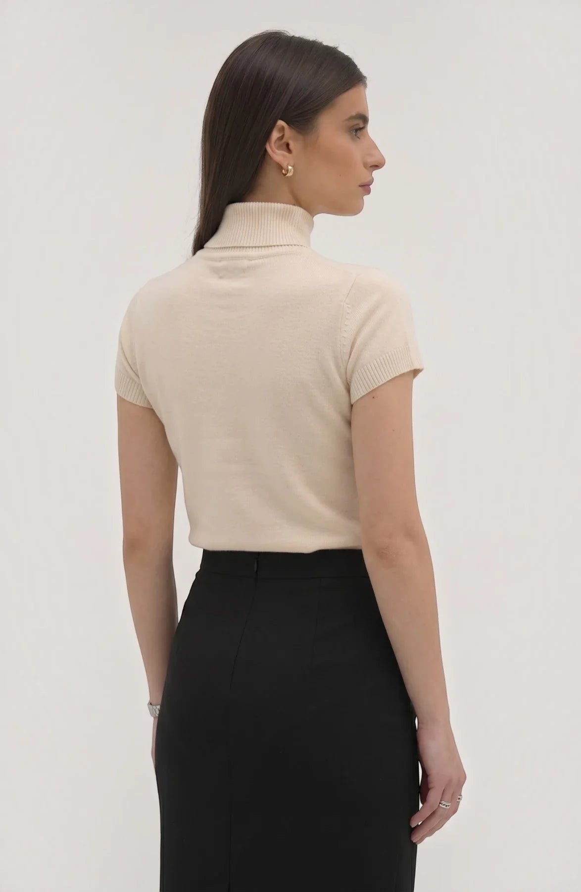 LORVENE Pure Poly Blend High Neck top shown in beige with a close-up of the high neckline and smooth fabric texture.