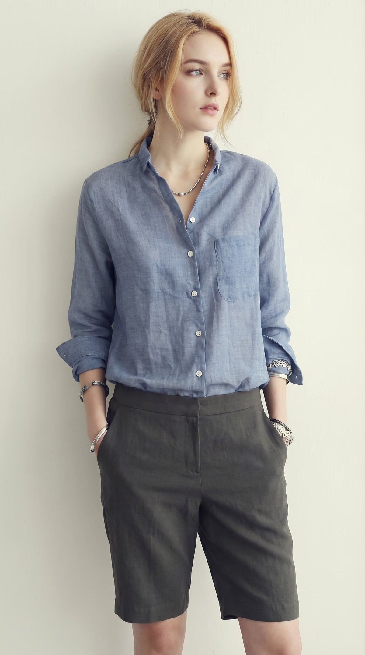 LORVENE classic button-up shirt in white, featuring a collared neckline and long sleeves, displayed on a hanger.