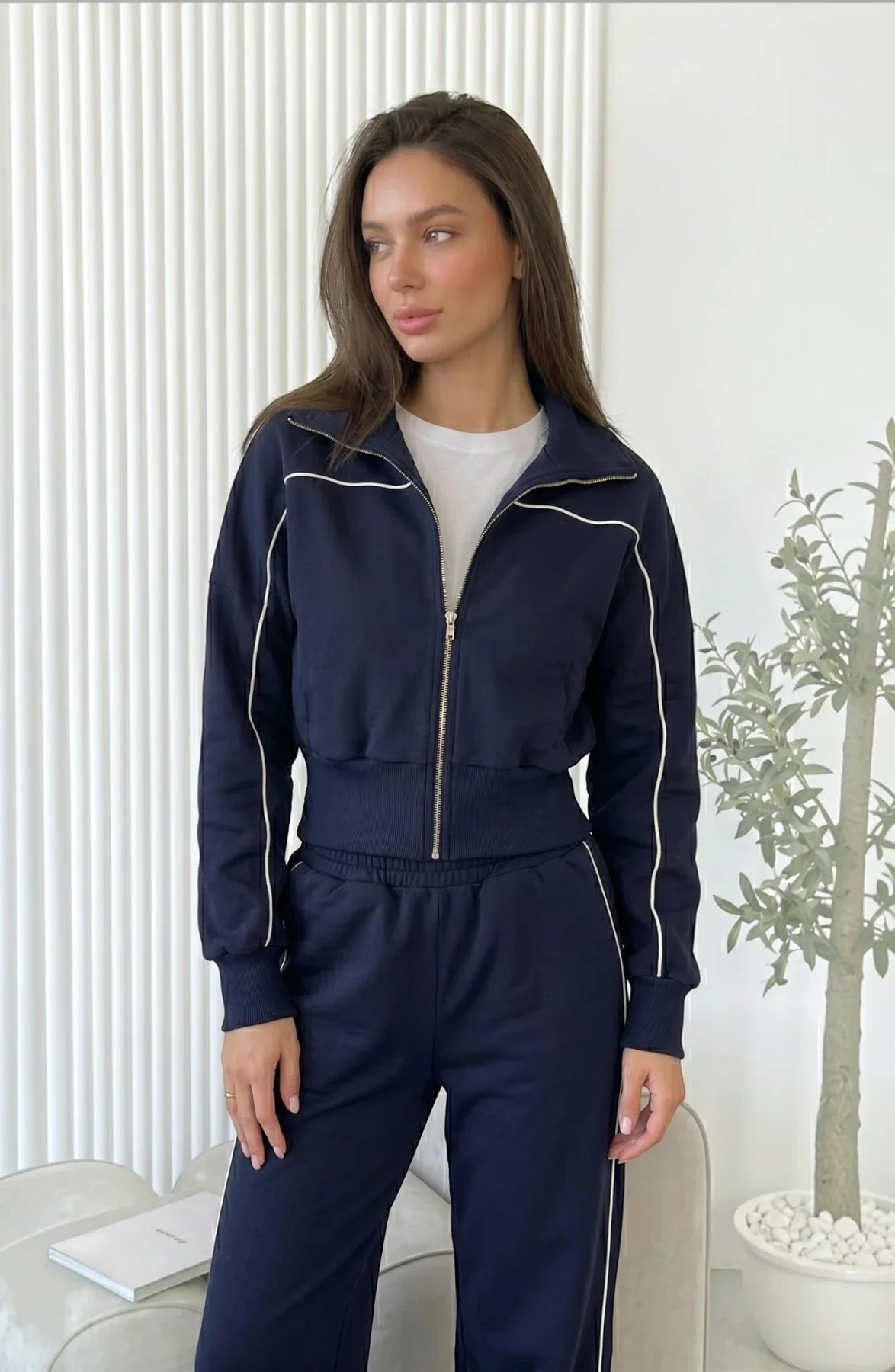 Model wearing LORVENES striped street cardigan set with matching top and pants, featuring colorful horizontal stripes.